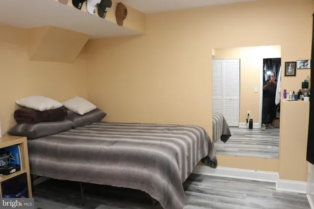 a bedroom with a bed and a painting on the wall