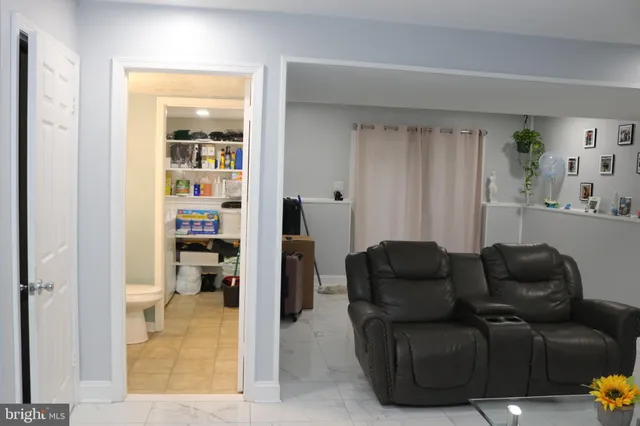 a living room with furniture and a book shelf