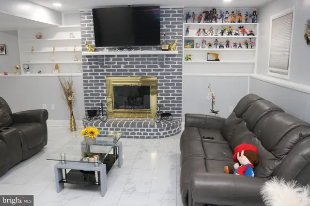 a living room with furniture fireplace and flat screen tv