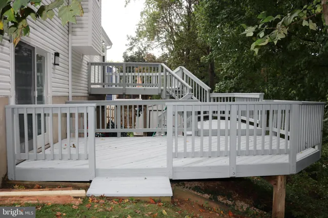 a view of a house with wooden deck