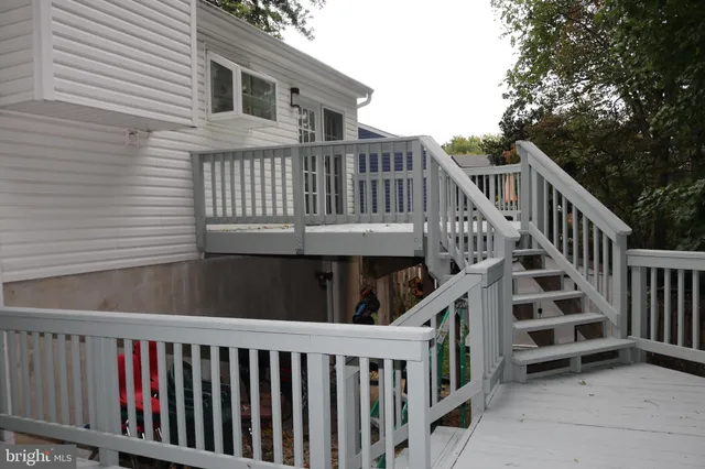 a view of a house with wooden deck