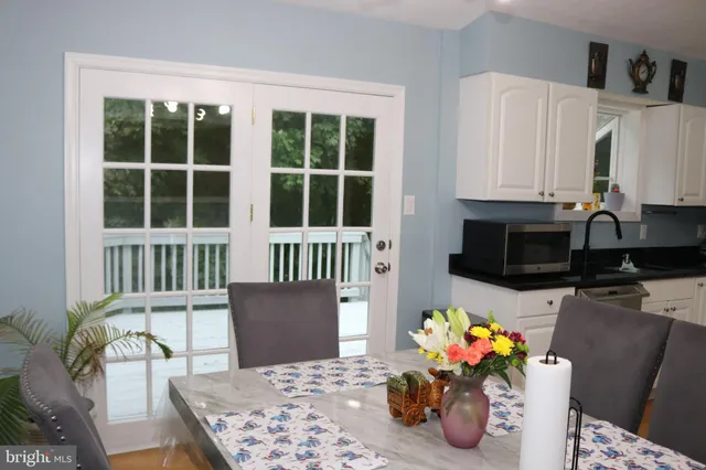 a view of a workspace with furniture and a kitchen