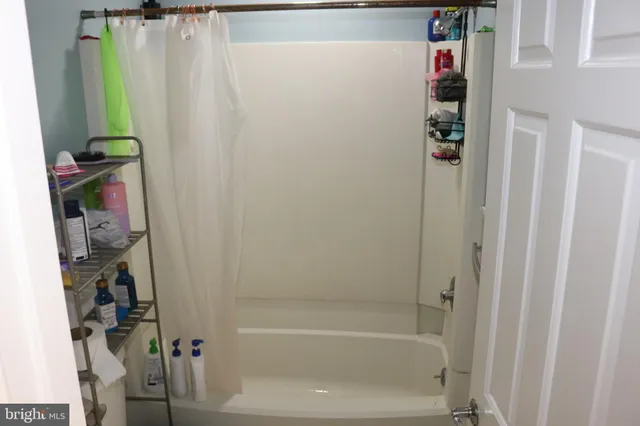 a bathroom with a bathtub and a shower