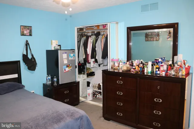 a bed room with a bed and a night stand