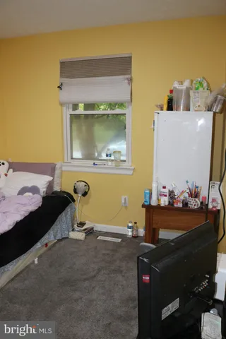 a bedroom with a bed and the dresser