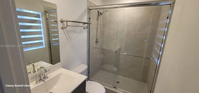 a bathroom with a shower and a sink