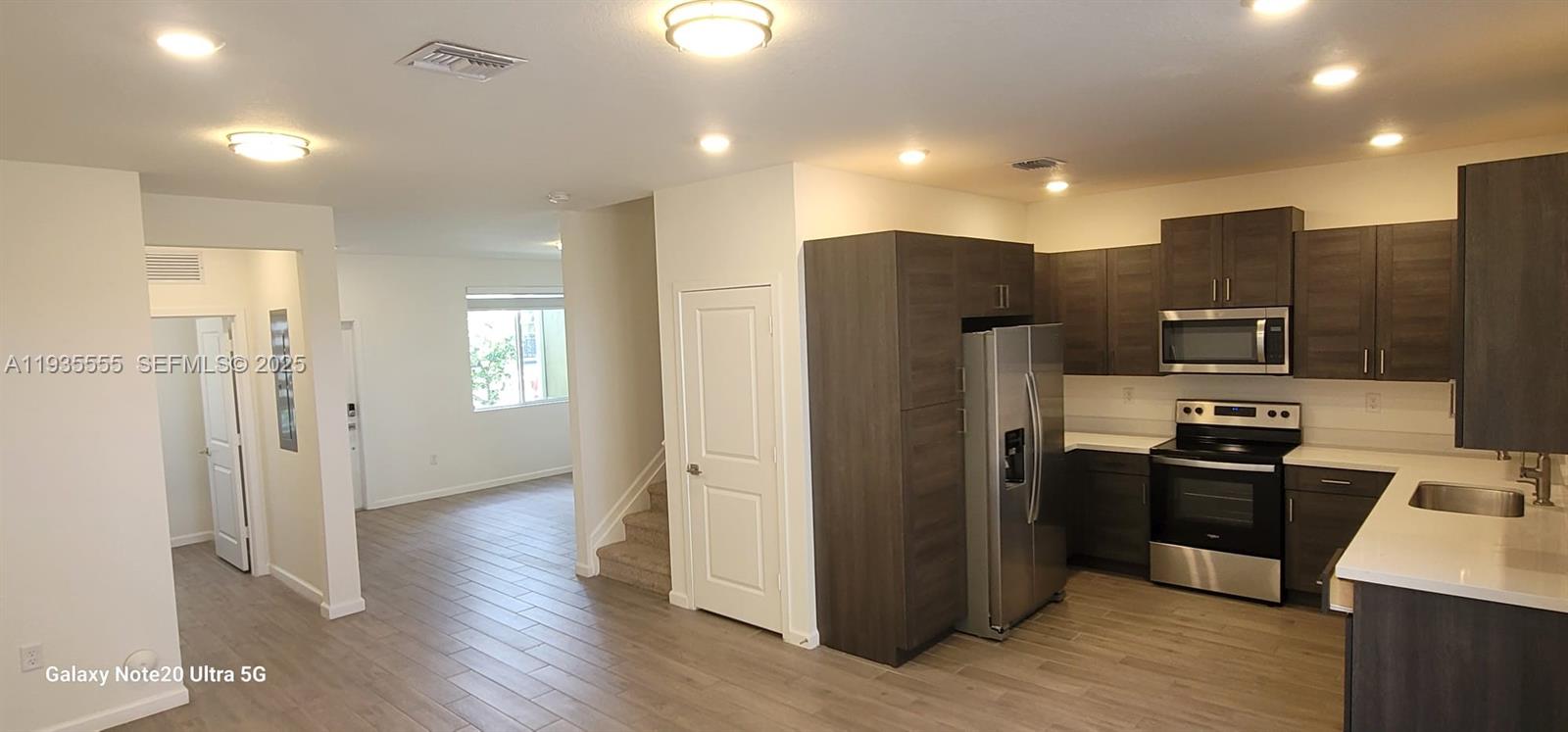 2459 Southeast 10th Street Homestead, FL 33035 - Photo 3 of 15 a kitchen with stainless steel appliances a refrigerator and a stove top oven