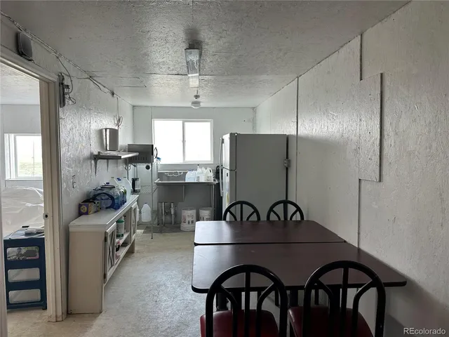 a kitchen with stainless steel appliances granite countertop a sink and a refrigerator