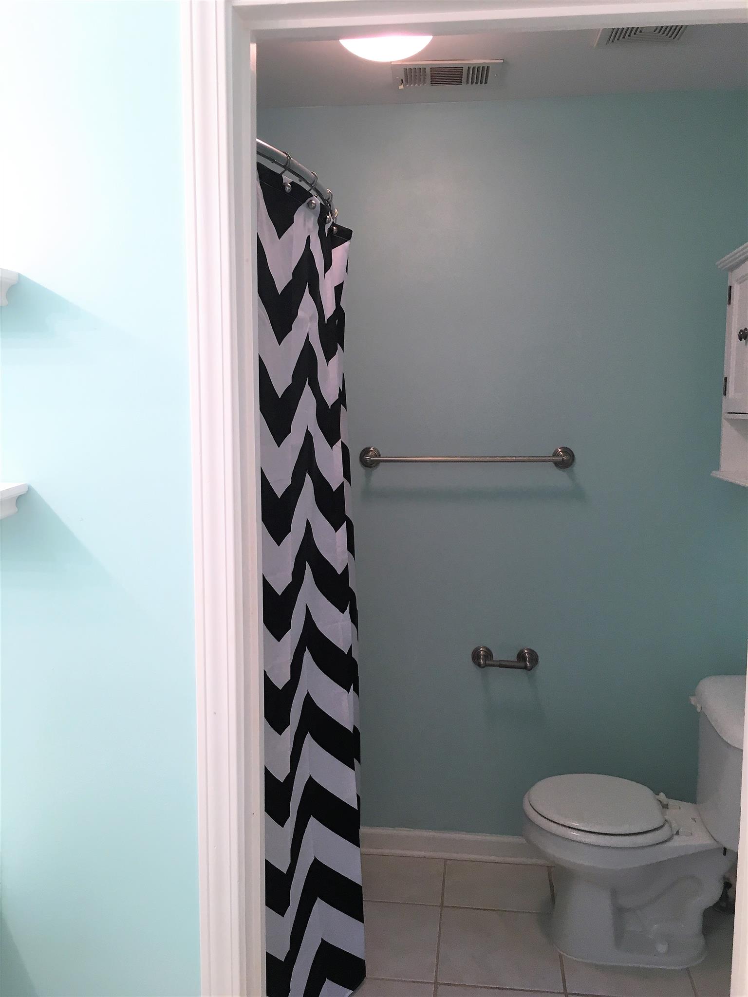 1101 Downs Boulevard, Unit A103 Franklin, TN 37064 - Photo 14 of 18 a bathroom with a toilet and a shower curtain
