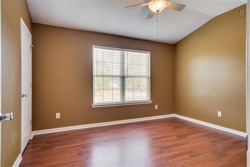 1101 Downs Boulevard, Unit A103 Franklin, TN 37064 - Photo 15 of 18 a view of an empty room with a window and a chandelier