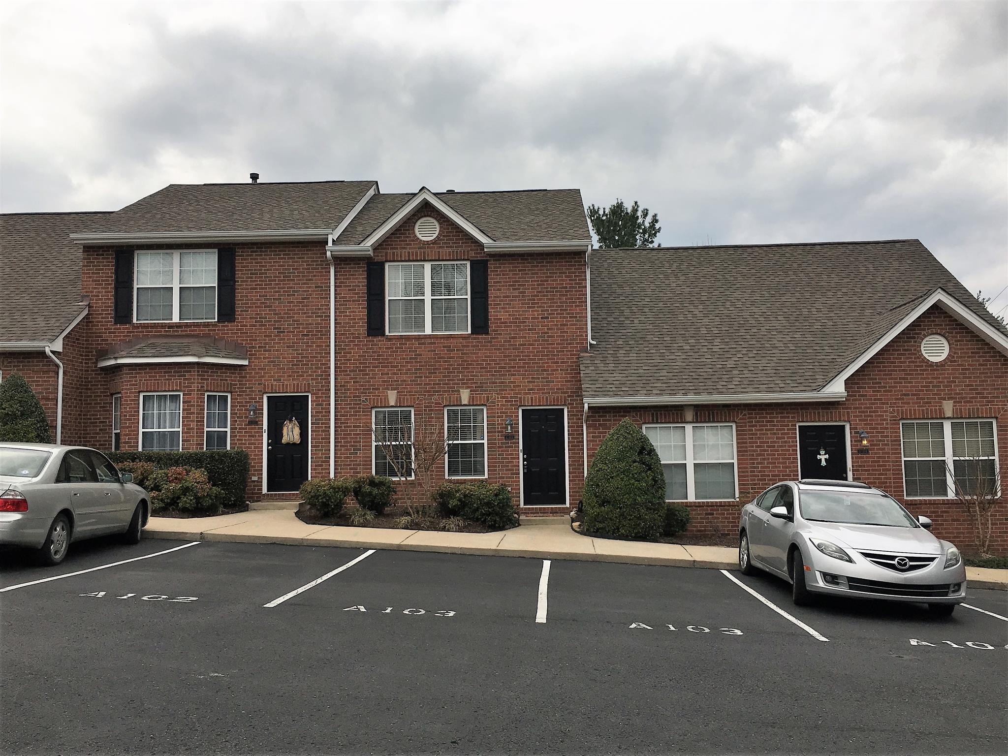 1101 Downs Boulevard, Unit A103 Franklin, TN 37064 - Photo 18 of 18 a front view of a house with cars parked
