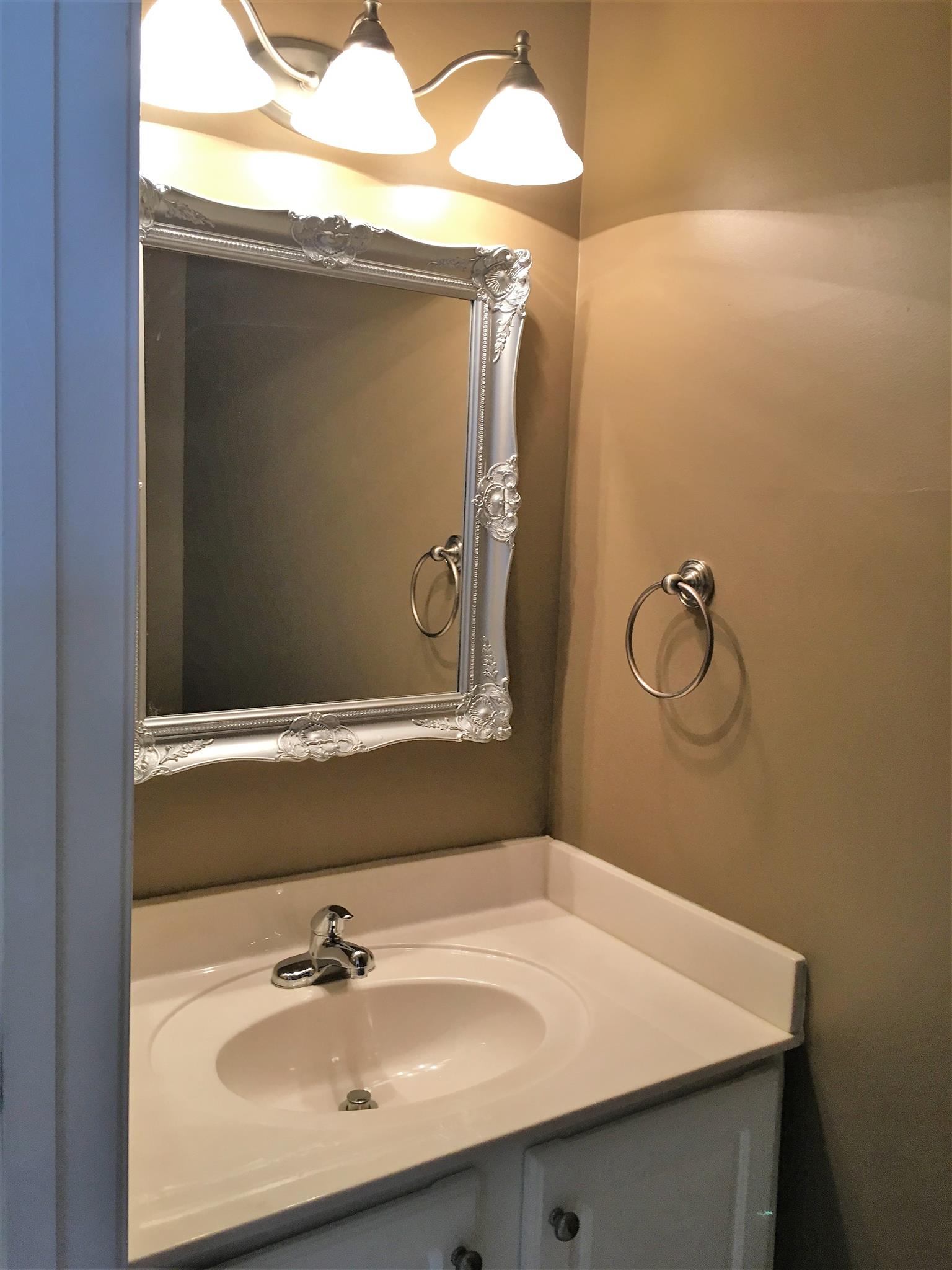 1101 Downs Boulevard, Unit A103 Franklin, TN 37064 - Photo 8 of 18 a bathroom with a sink and mirror