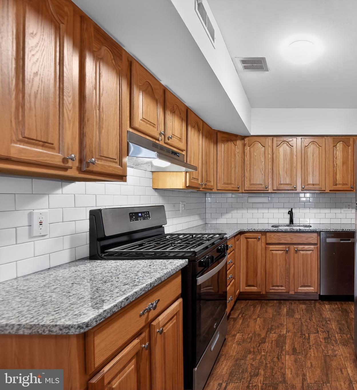 411 Stiles Avenue, Unit B11 Maple Shade, NJ 08052 - Photo 12 of 25 a kitchen with stainless steel appliances granite countertop a stove sink and cabinets
