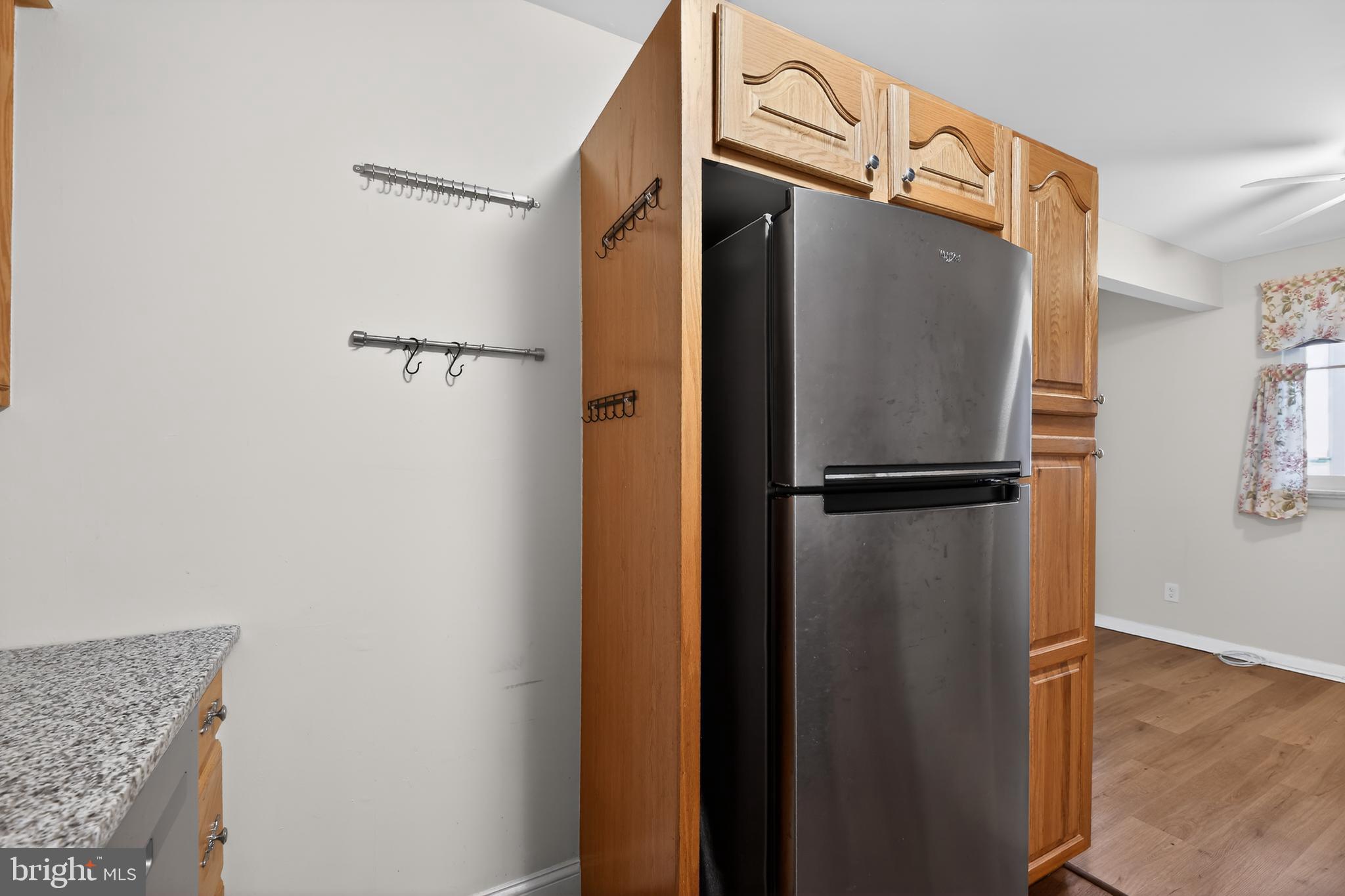 411 Stiles Avenue, Unit B11 Maple Shade, NJ 08052 - Photo 13 of 25 a bathroom with a refrigerator and a wooden floor