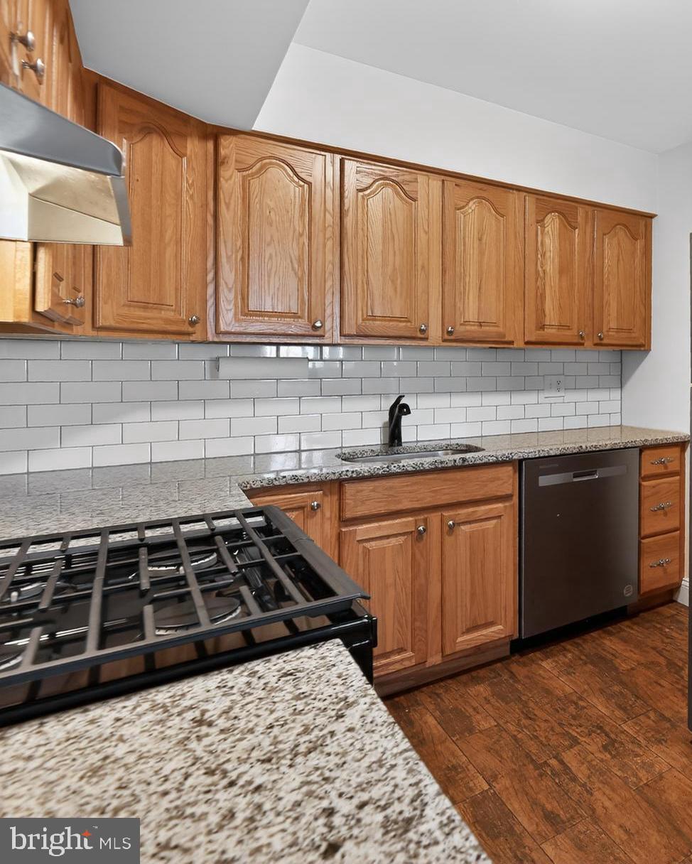 411 Stiles Avenue, Unit B11 Maple Shade, NJ 08052 - Photo 14 of 25 a kitchen with a sink a stove and cabinets