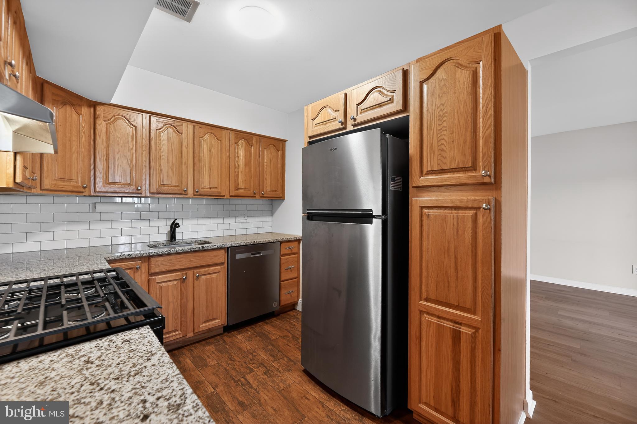 411 Stiles Avenue, Unit B11 Maple Shade, NJ 08052 - Photo 15 of 25 a kitchen with stainless steel appliances granite countertop a refrigerator and a stove top oven