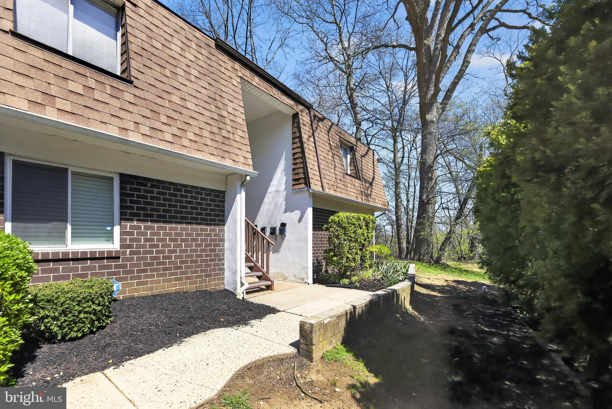 411 Stiles Avenue, Unit B11 Maple Shade, NJ 08052 - Photo 2 of 25 a view of a house with a small yard and a large tree