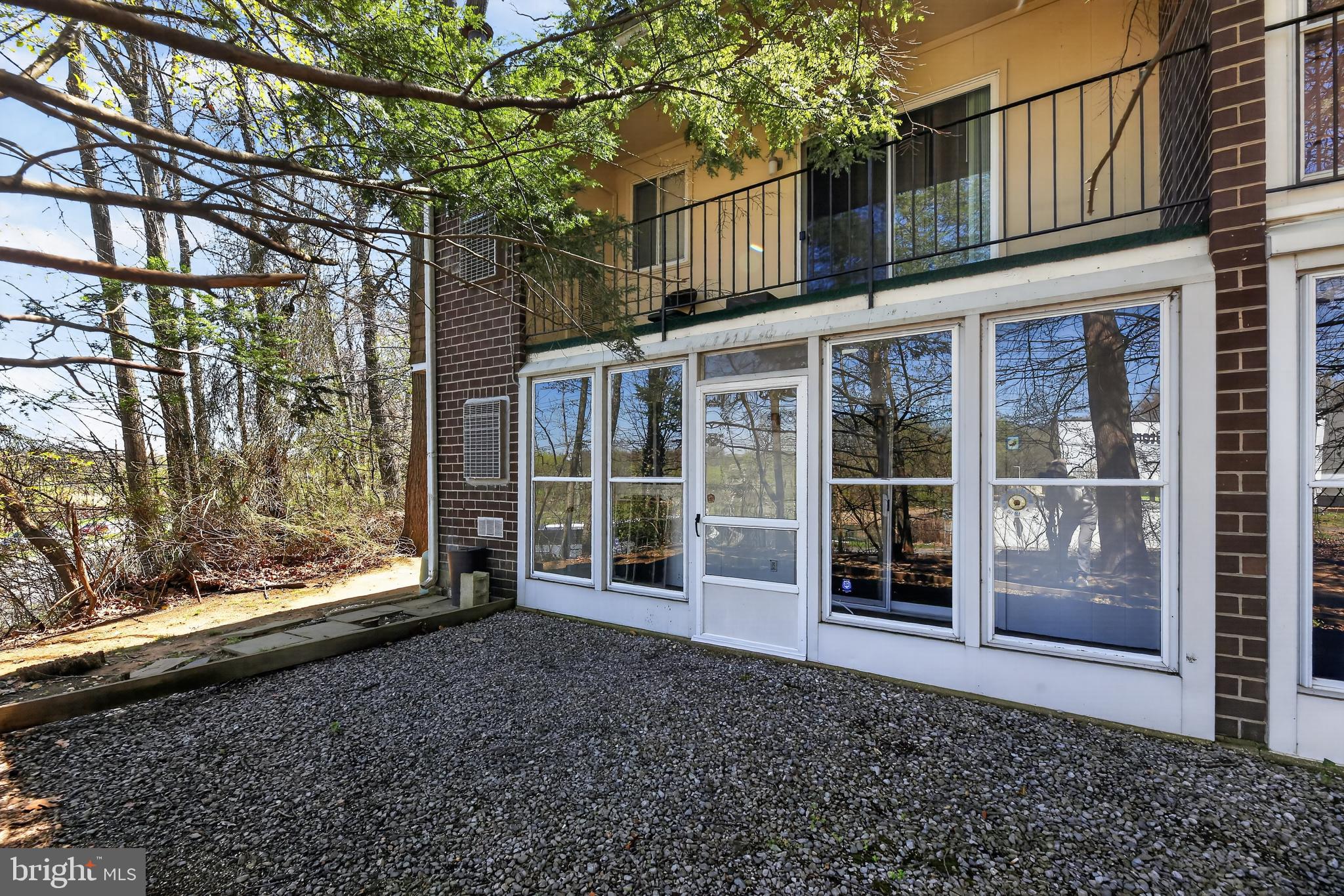 411 Stiles Avenue, Unit B11 Maple Shade, NJ 08052 - Photo 24 of 25 a view of a brick house with a large window and yard