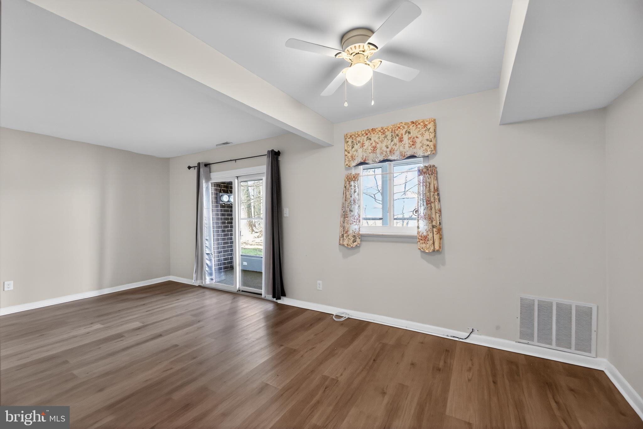 411 Stiles Avenue, Unit B11 Maple Shade, NJ 08052 - Photo 7 of 25 a view of an empty room with a window and wooden floor