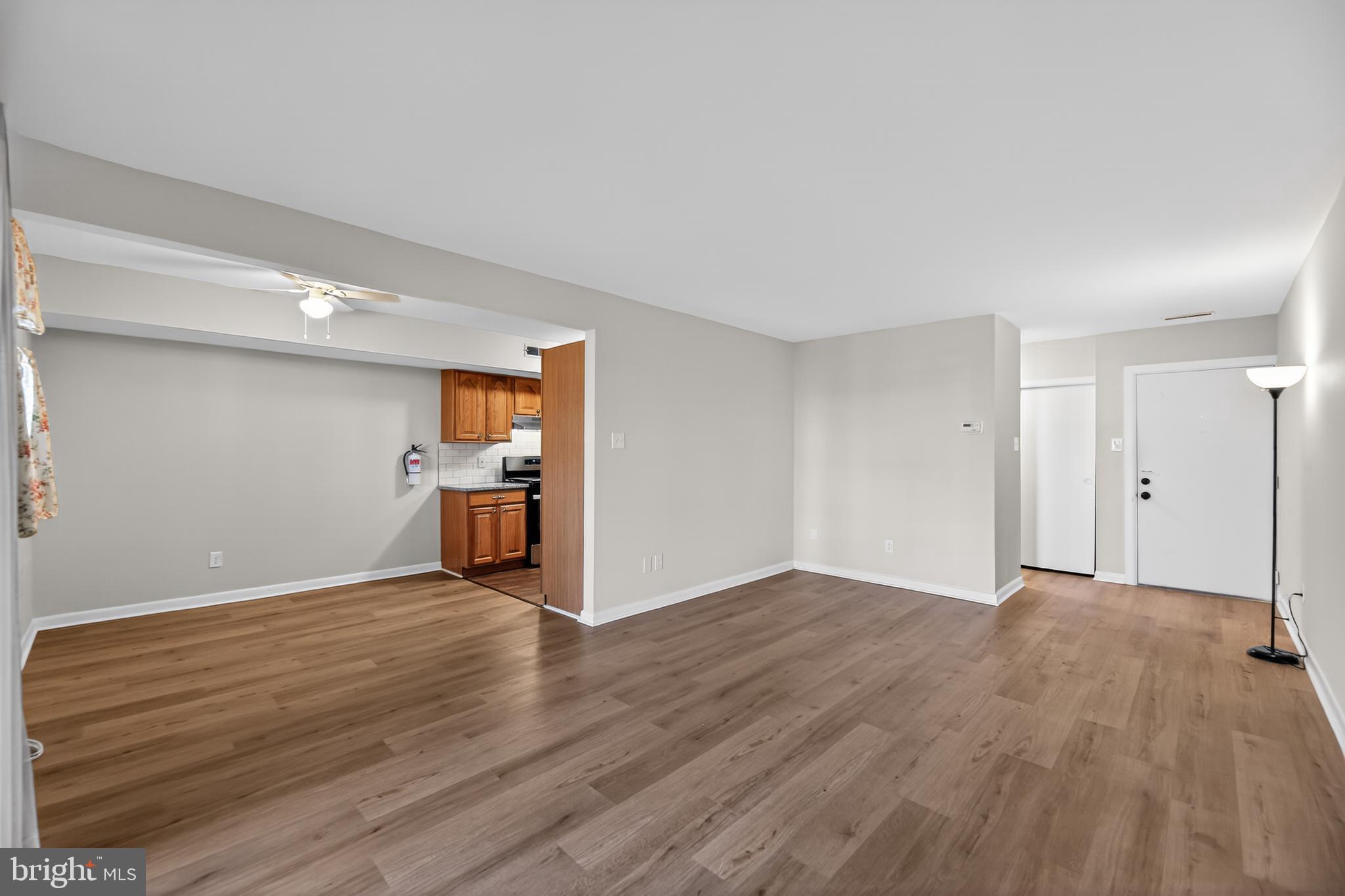 411 Stiles Avenue, Unit B11 Maple Shade, NJ 08052 - Photo 9 of 25 a view of a big room with wooden floor and a window