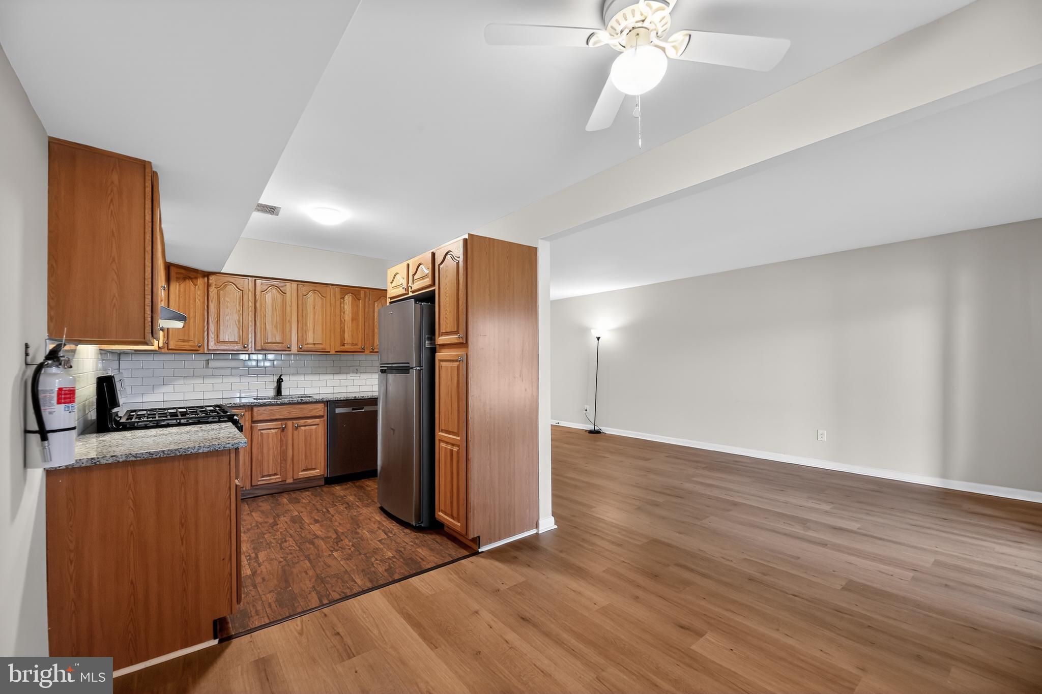 411 Stiles Avenue, Unit B11 Maple Shade, NJ 08052 - Photo 10 of 25 a kitchen with granite countertop a refrigerator stove and sink