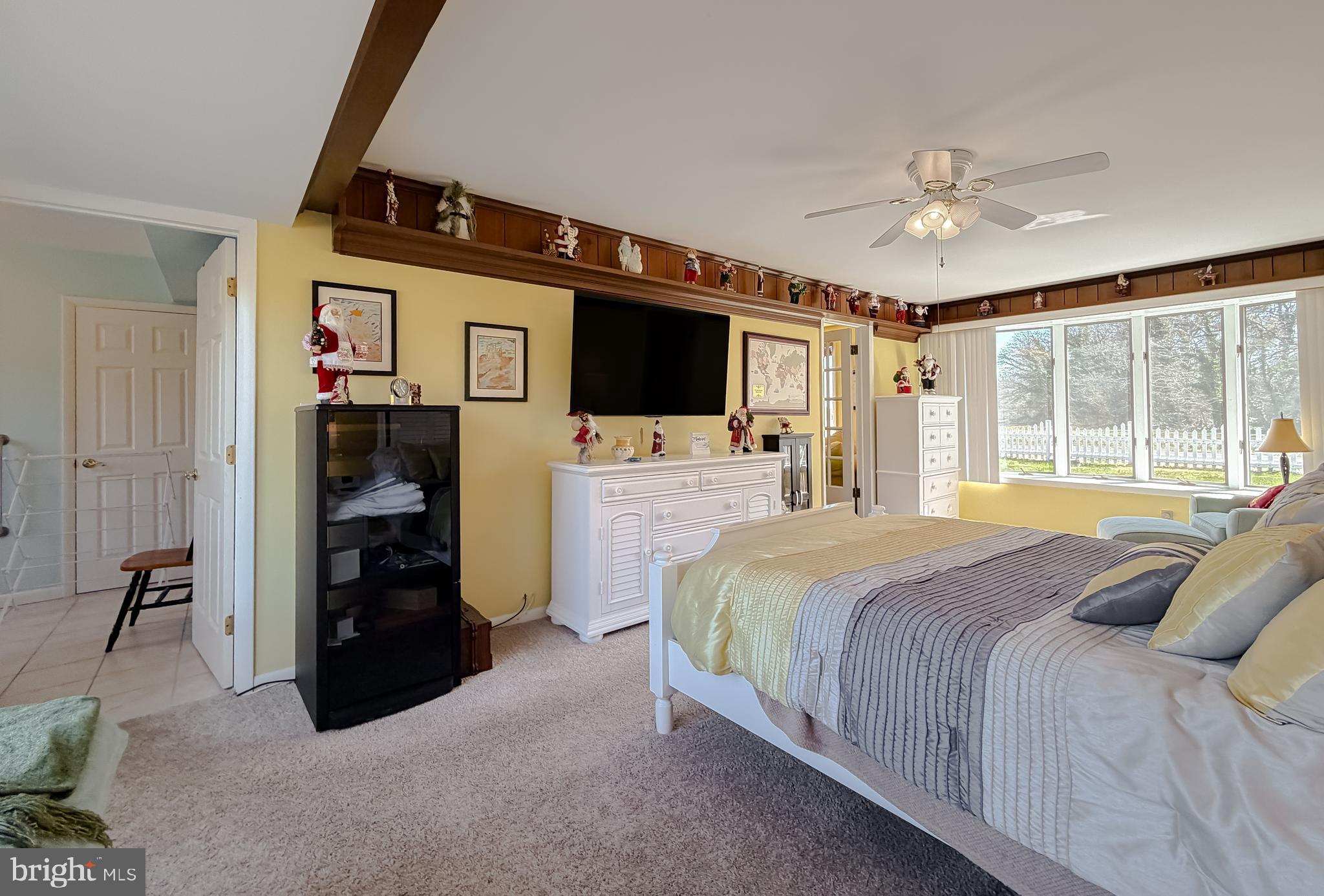 49716 Airedele Road Ridge, MD 20680 - Photo 49 of 101 a bedroom with a bed and a flat tv screen