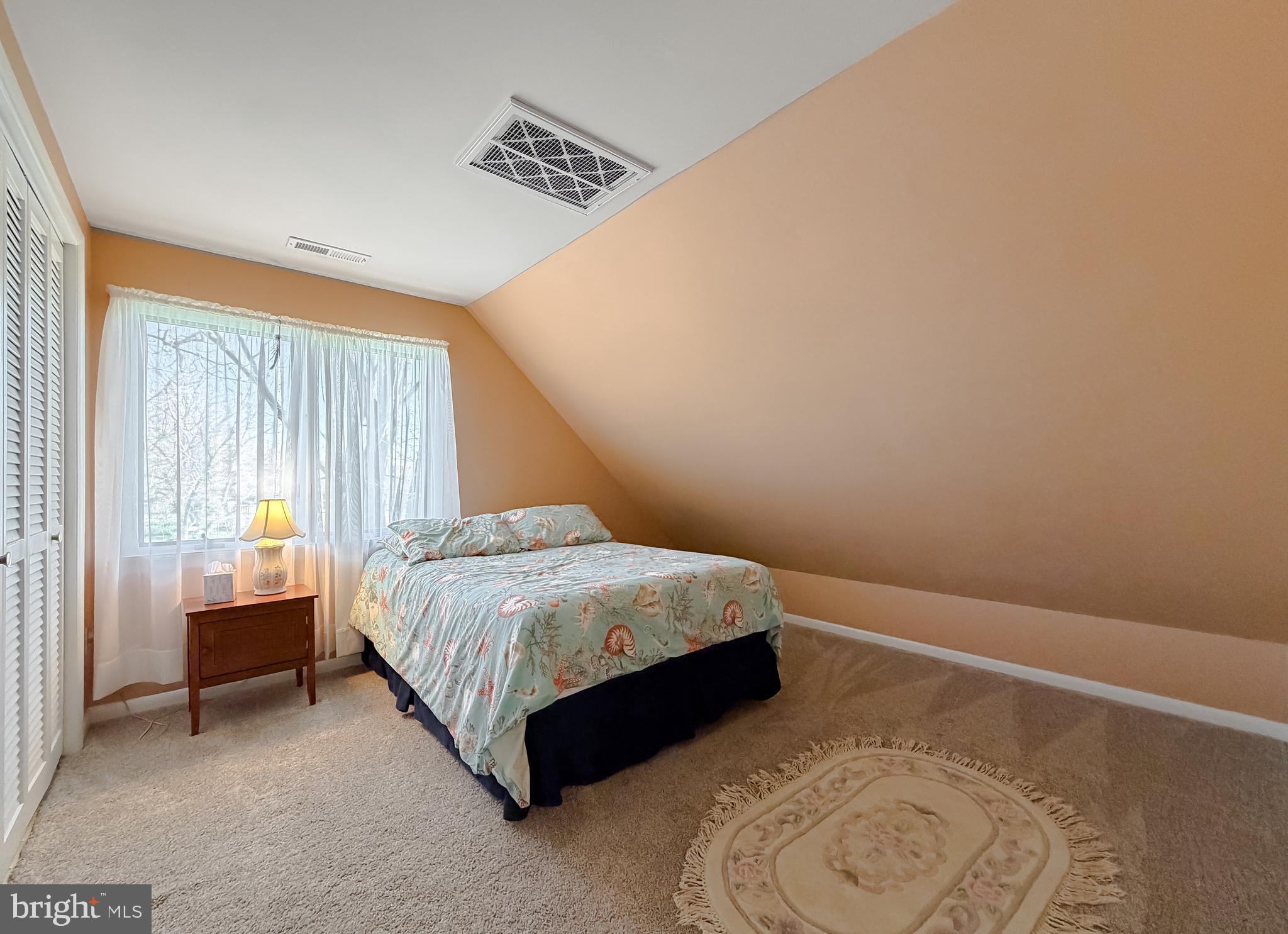 49716 Airedele Road Ridge, MD 20680 - Photo 60 of 101 a bed sitting in a spacious bedroom next to a window