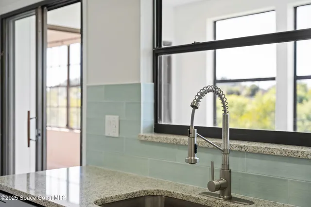 a view of a kitchen with wooden floor and electronic appliances