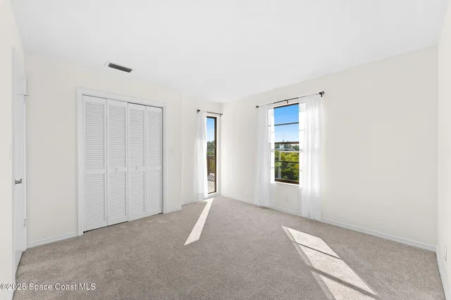 a bathroom with a granite countertop sink mirror vanity and toilet