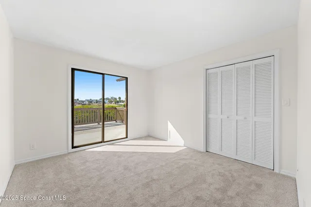 a view of an empty room with a balcony
