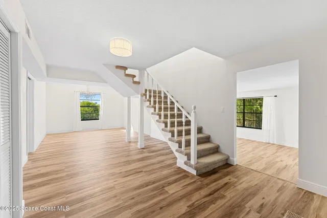 a view of entryway and hall with wooden floor
