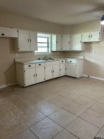 a kitchen with cabinets and window
