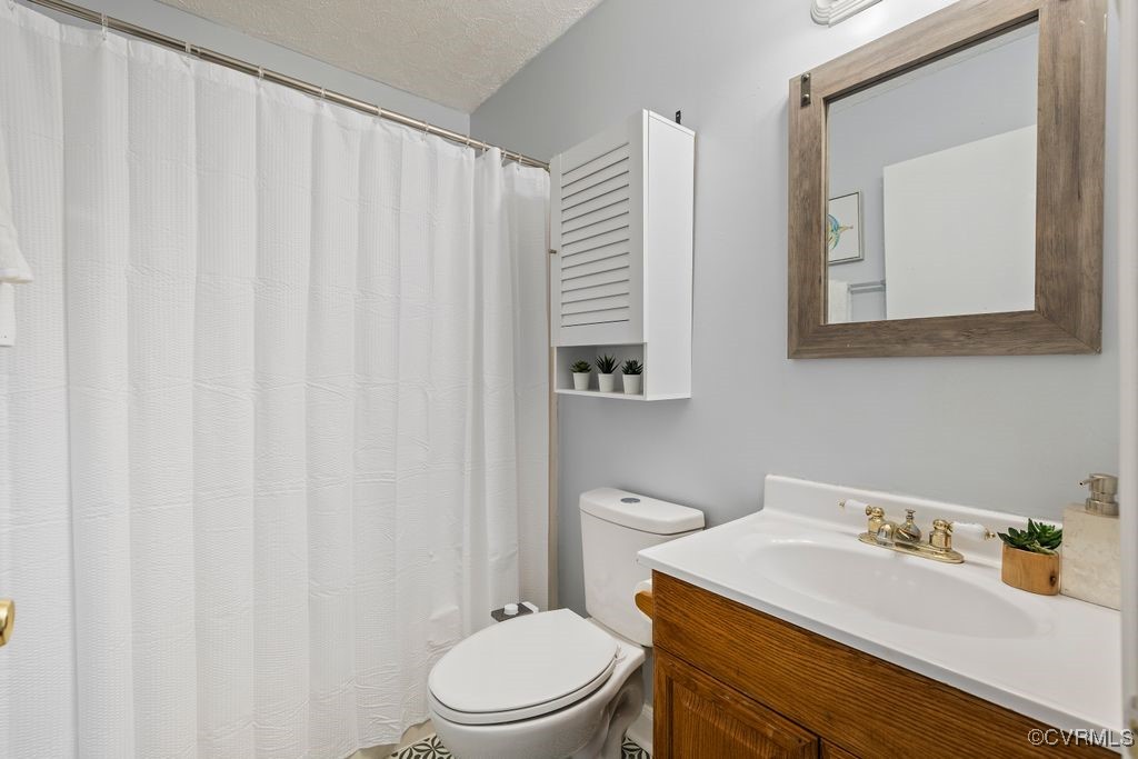 11041 Moravia Road Midlothian, VA 23112 - Photo 11 of 38 a bathroom with a sink a toilet and a mirror