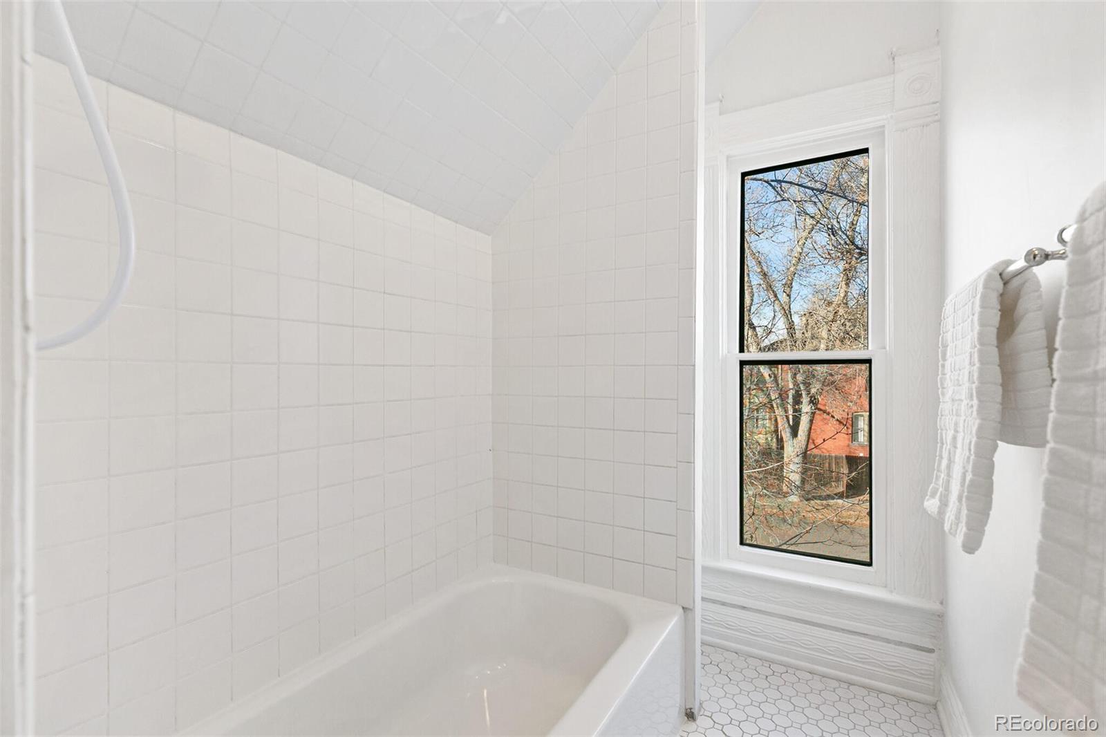 3885 Wolff Street Denver, CO 80212 - Photo 34 of 50 a bathroom with bathtub and window