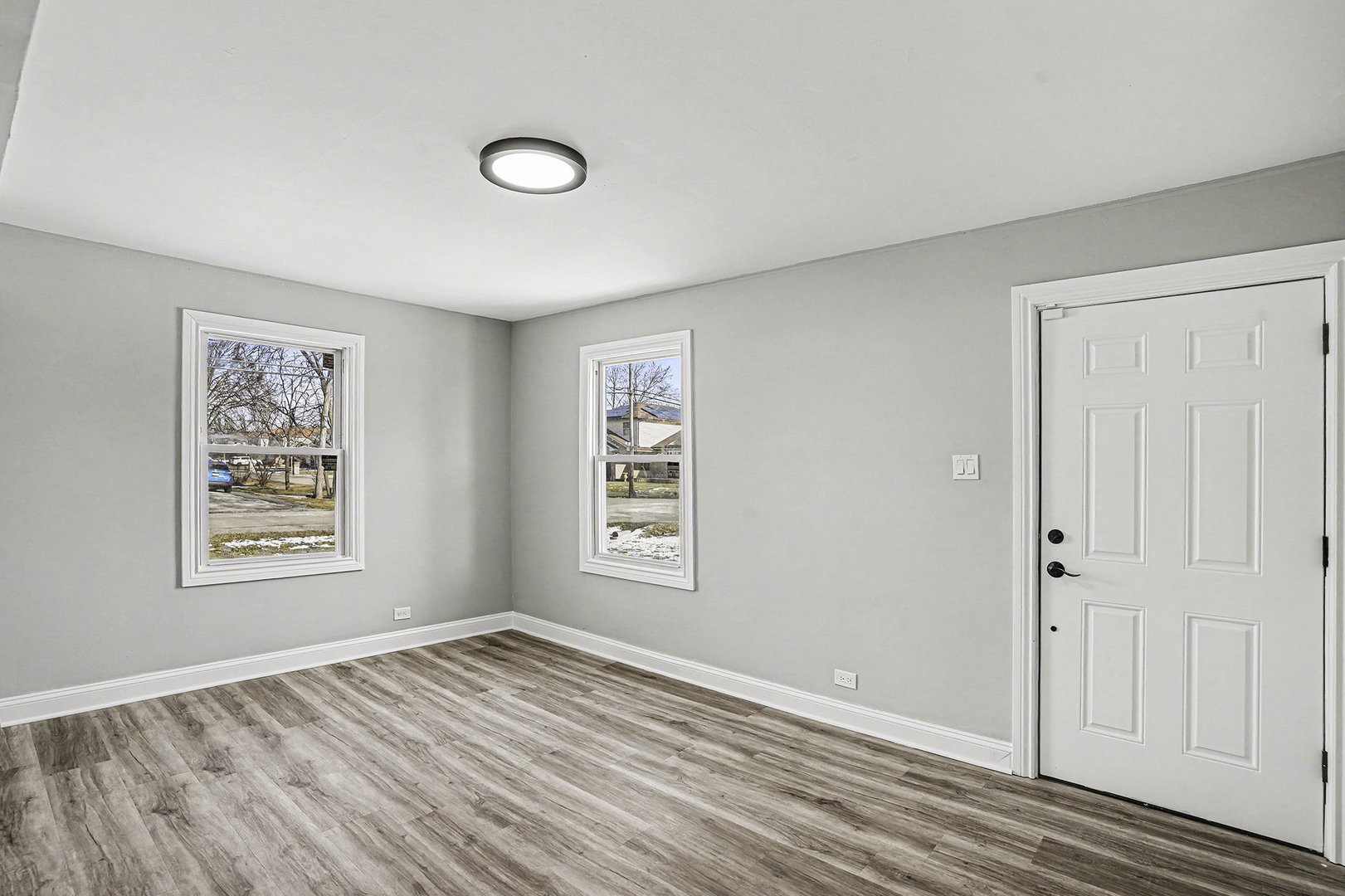 15700 Turner Avenue Markham, IL 60428 - Photo 4 of 15 a view of an empty room with a window and wooden floor