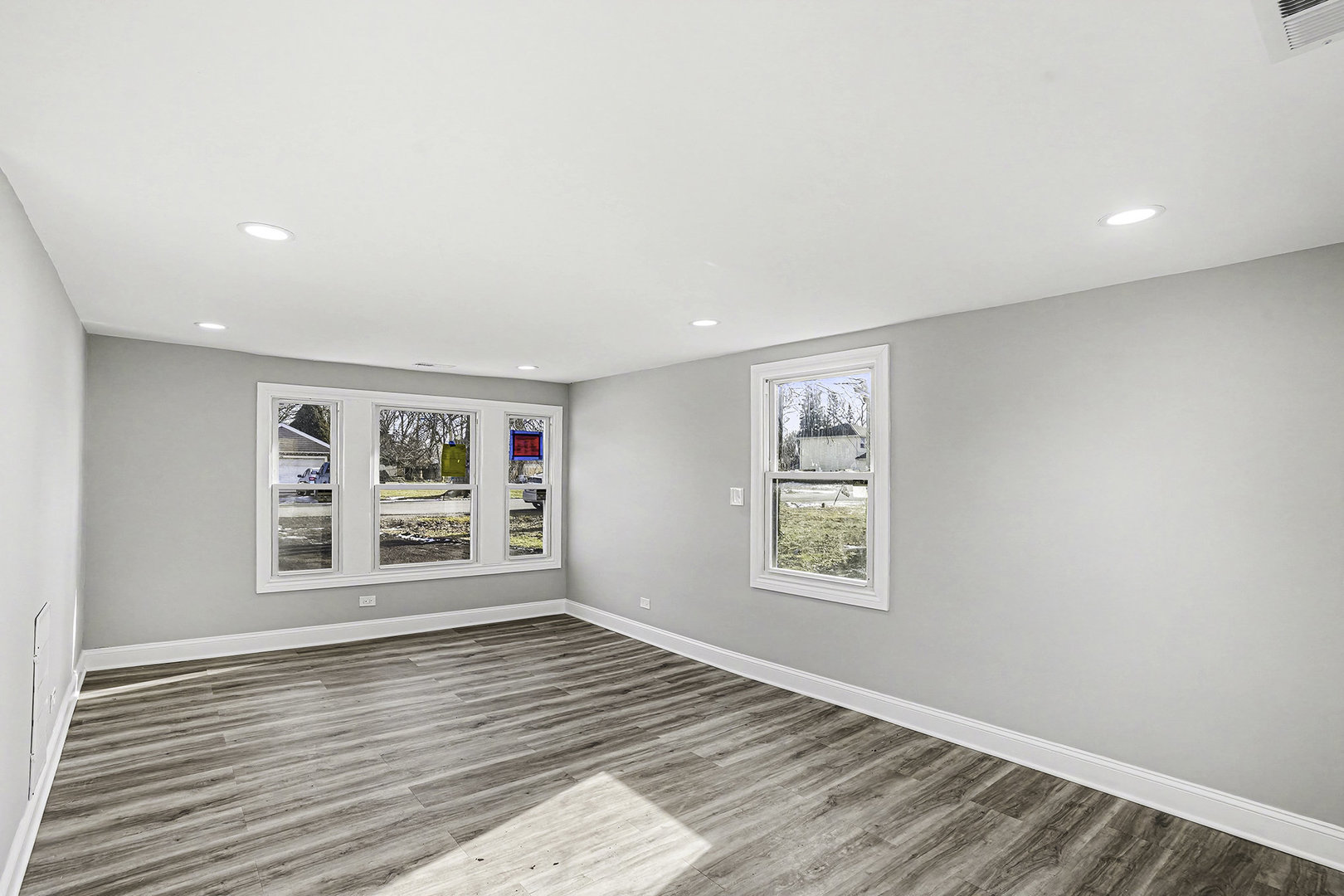 15700 Turner Avenue Markham, IL 60428 - Photo 5 of 15 a view of an empty room with a window and wooden floor