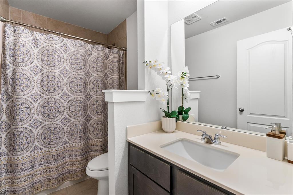 2407 Neff Lane Forney, TX 75126 - Photo 19 of 22 a bathroom with a sink and mirror with toilet