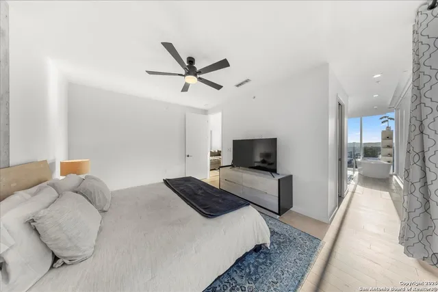 a bedroom with a bed and a television