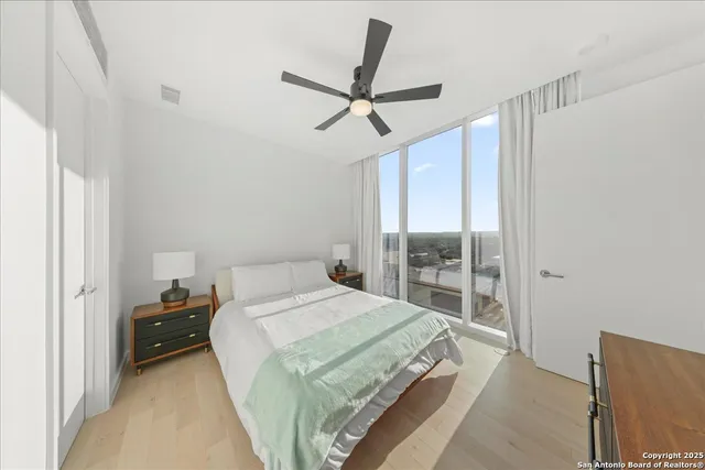 a bedroom with a bed and a large window