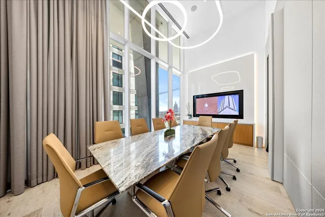 a dining room with furniture and a flat screen tv