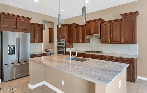 a large kitchen with cabinets and stainless steel appliances