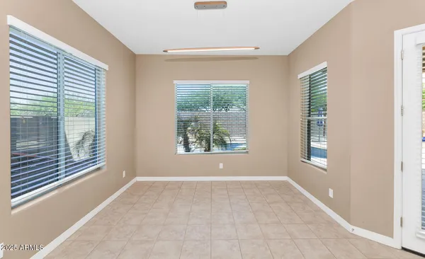 an empty room with closet and fan