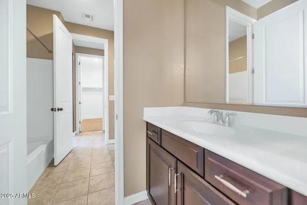 en empty room with closet and a chandelier fan
