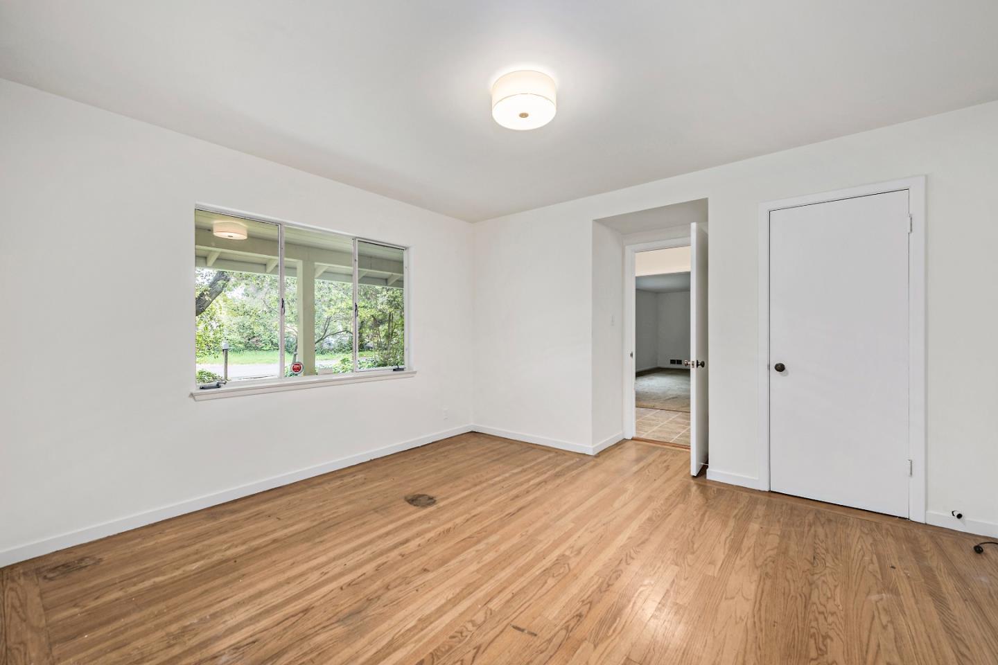 96 Edge Road Atherton, CA 94027 - Photo 17 of 28 an empty room with wooden floor and windows