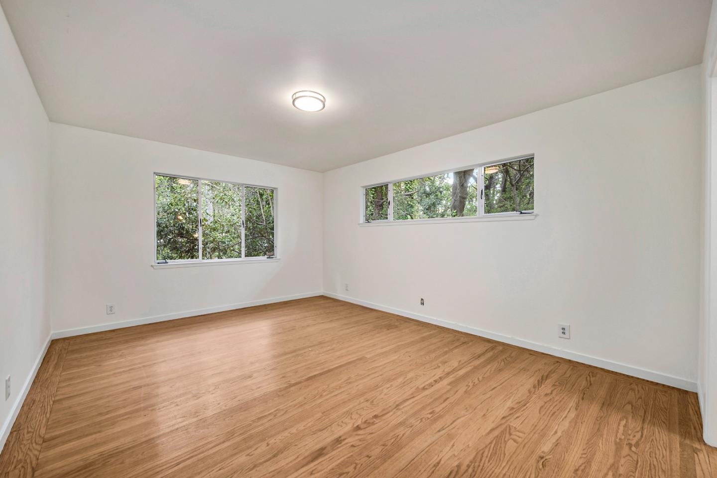 96 Edge Road Atherton, CA 94027 - Photo 18 of 28 an empty room with wooden floor and windows
