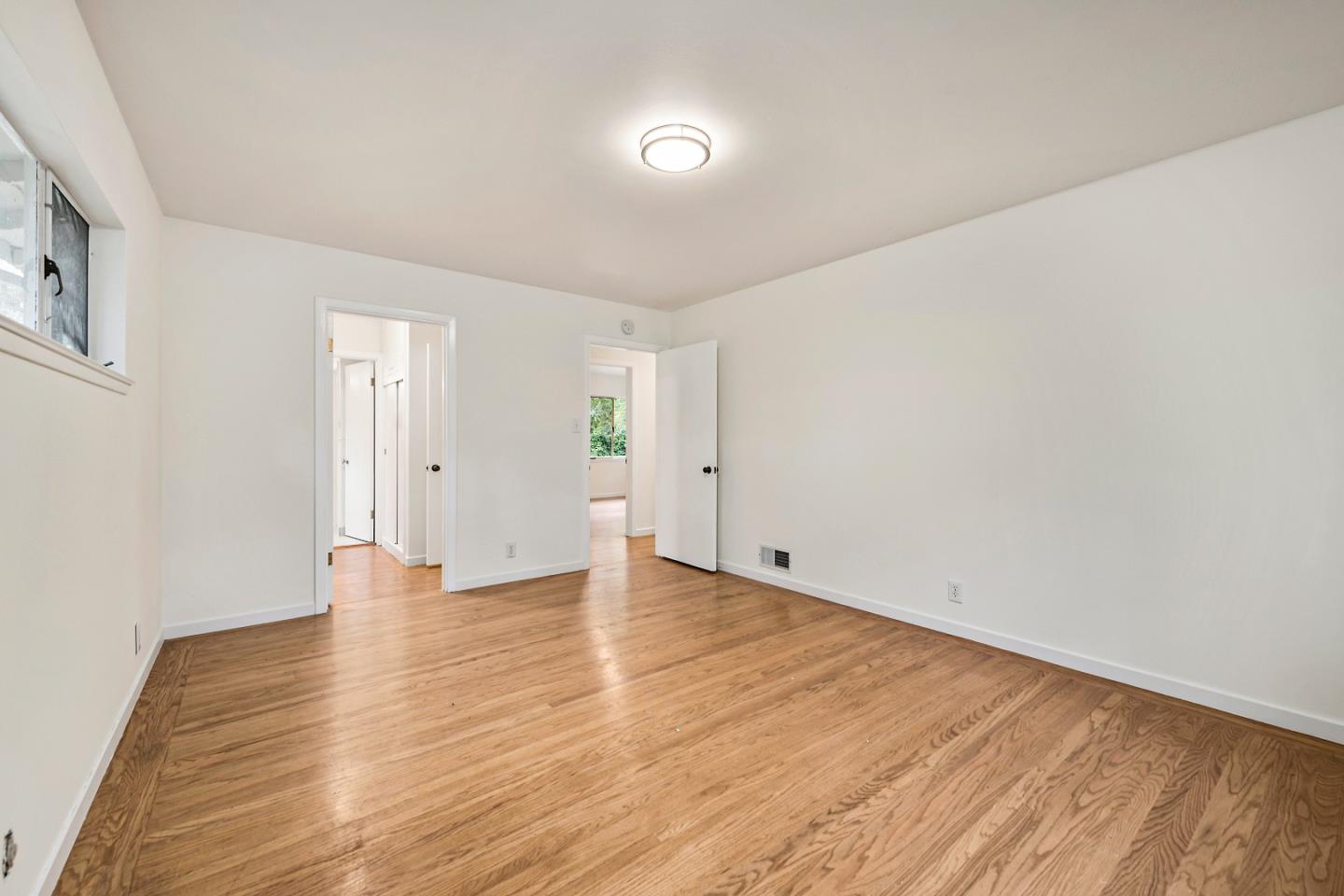 96 Edge Road Atherton, CA 94027 - Photo 20 of 28 a view of an empty room with wooden floor and a window