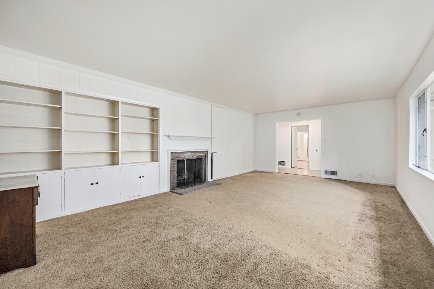 96 Edge Road Atherton, CA 94027 - Photo 6 of 28 a view of an empty room with a fireplace and cabinet