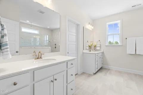a bathroom with a sink vanity and a mirror
