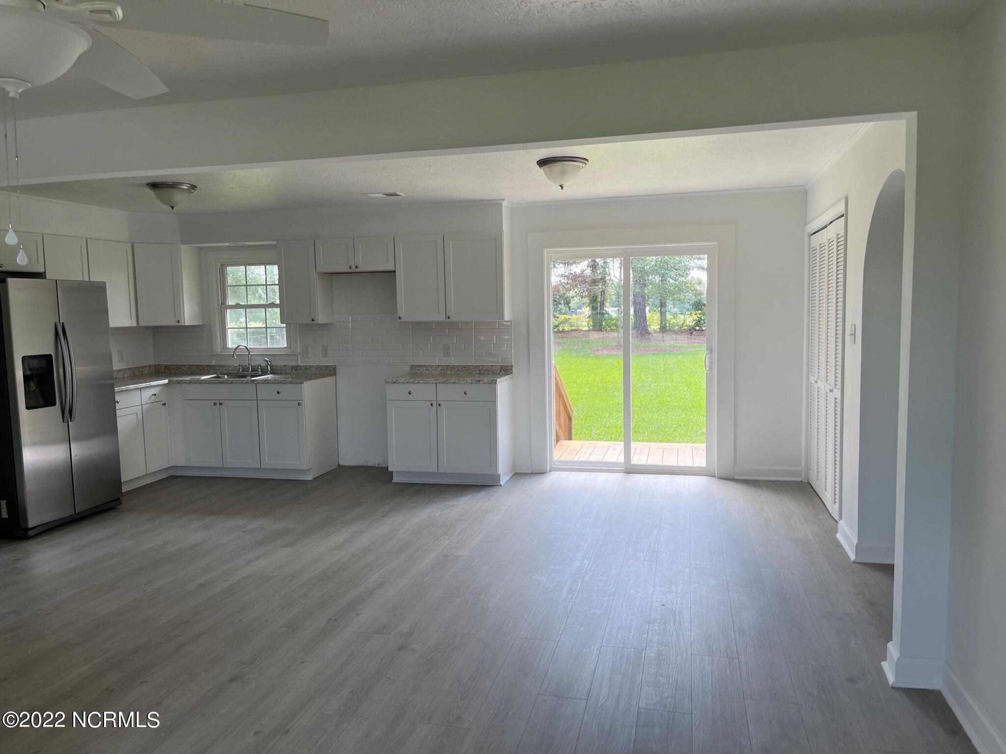 2240 Bird Cage Road Chadbourn, NC 28431 - Photo 2 of 16 Sliding glass door off of the dining area lead to a brand new deck and huge back yard surrounded by a treeline on 3 sides.