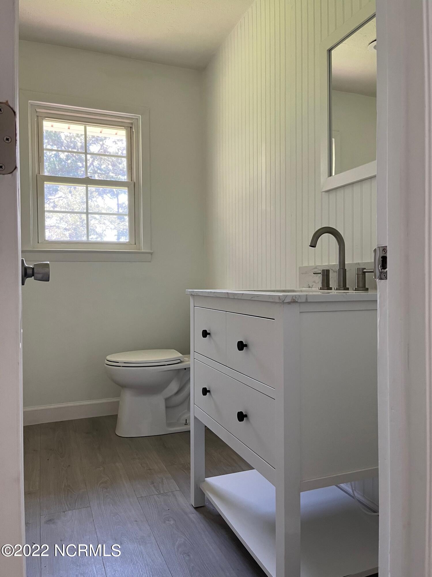 2240 Bird Cage Road Chadbourn, NC 28431 - Photo 6 of 16 guest bathroom off of hallway with 2 bedrooms and an office